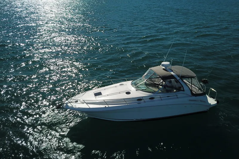 Slide: The Image of 2005 Sea Ray 360 Sundancer yacht cruising on sparkling blue water. - 6