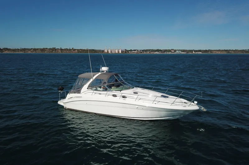 Slide: The Image of 2005 Sea Ray 360 Sundancer yacht cruising on open water under clear blue skies. - 9