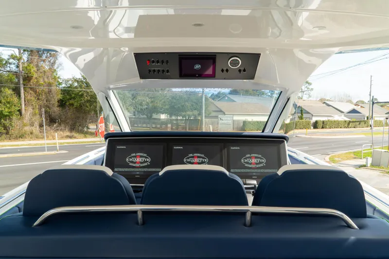 Slide: The Image of 2023 Cigarette 41' Nighthawk boat cockpit with advanced navigation screens and controls. - 5