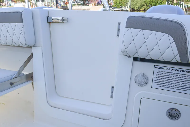 Slide: The Image of 2022 World Cat 280 CC-X boat interior with cushioned seating and safety notice. - 13