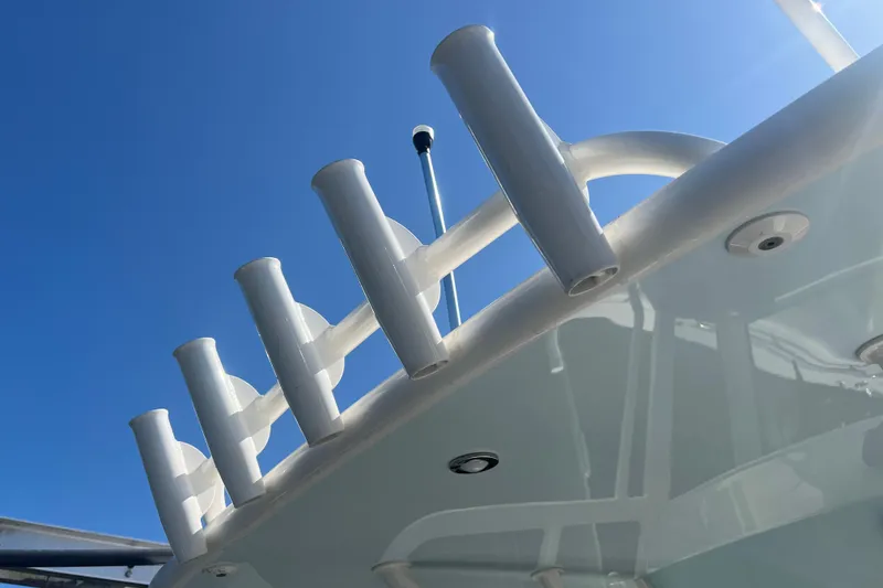 Slide: The Image of 2022 World Cat 280 CC-X boat with rod holders against clear blue sky. - 16