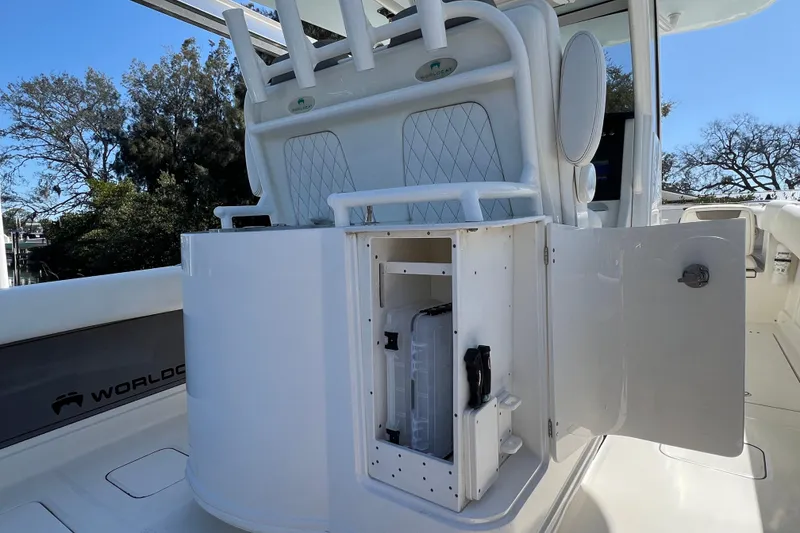 Slide: The Image of 2022 World Cat 280 CC-X boat interior with open storage compartment and rod holders. - 17