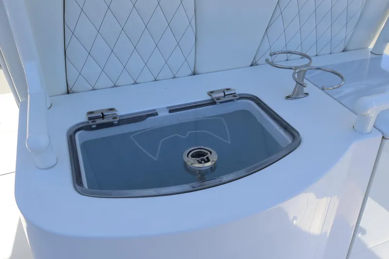 Slide: The Image of 2022 World Cat 280 CC-X boat console with livewell and cup holders. - 19