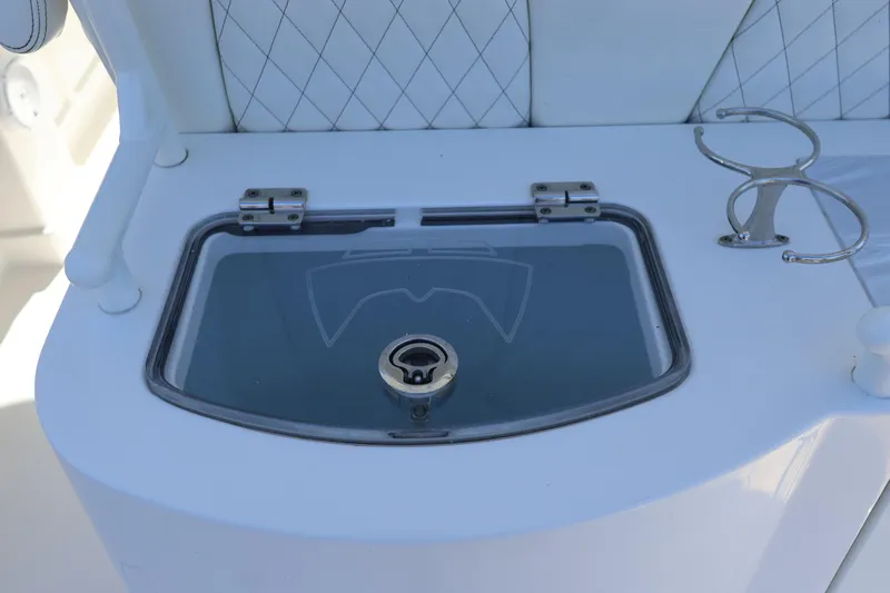 Slide: The Image of 2022 World Cat 280 CC-X boat detail with storage compartment and cup holder. - 20