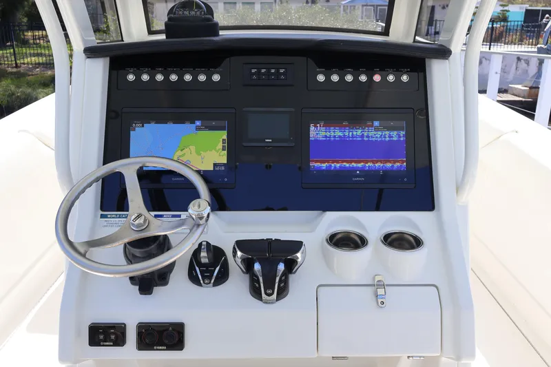 Slide: The Image of 2022 World Cat 280 CC-X boat dashboard with navigation screens and steering wheel. - 27
