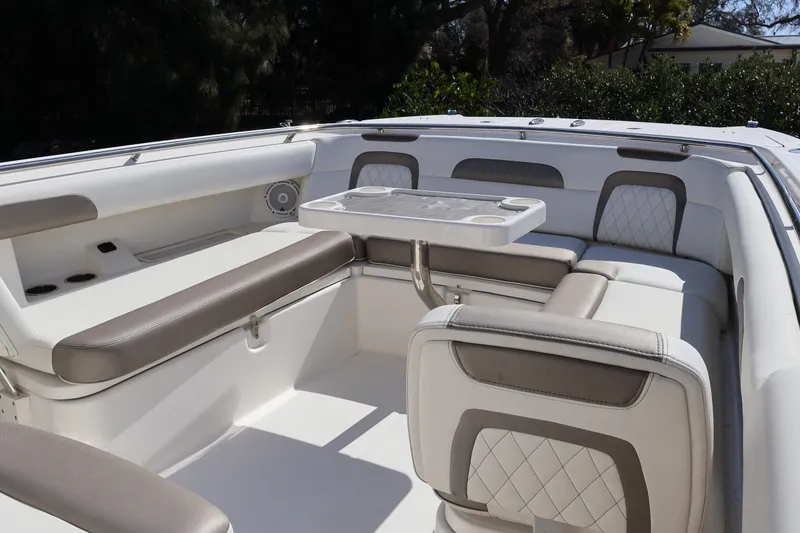 Slide: The Image of 2022 World Cat 280 CC-X boat interior with cushioned seating and table. - 36