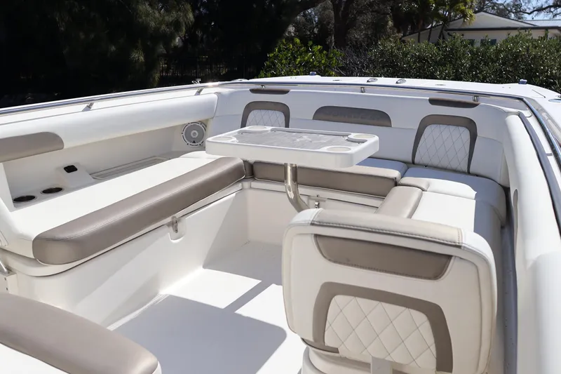 Slide: The Image of 2022 World Cat 280 CC-X boat interior with cushioned seating and table. - 37