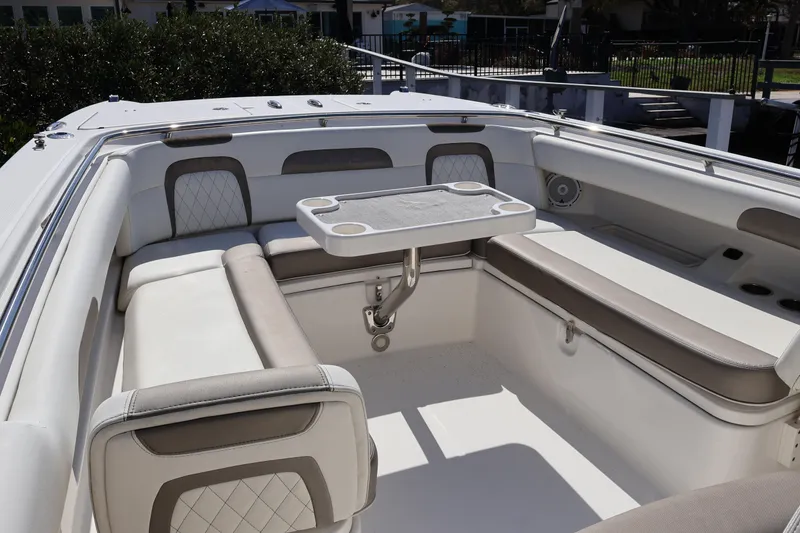 Slide: The Image of 2022 World Cat 280 CC-X boat interior with cushioned seating and table. - 38
