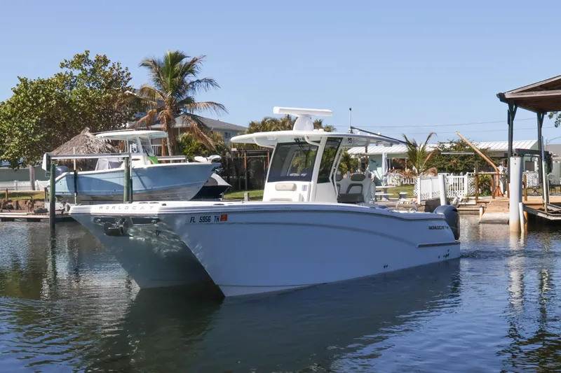 Slide: The Image of 2022 World Cat 280 CC-X boat docked in a serene marina setting. - 4