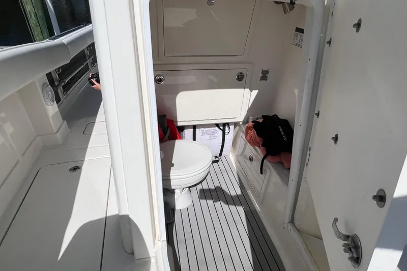 Slide: The Image of 2022 World Cat 280 CC-X boat interior with compact bathroom and storage. - 45