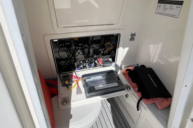 Slide: The Image of 2022 World Cat 280 CC-X electrical compartment with wiring and Garmin equipment. - 47