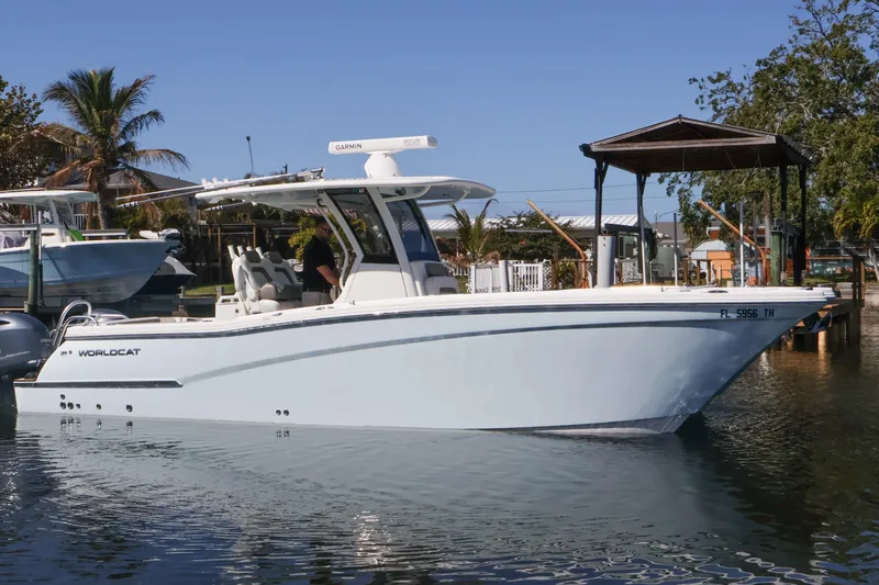 Slide: The Image of 2022 World Cat 280 CC-X boat docked in a sunny marina setting. - 5