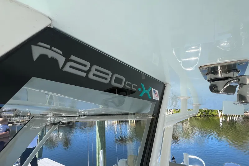Slide: The Image of 2022 World Cat 280 CC-X boat detail with logo, docked by the water. - 50