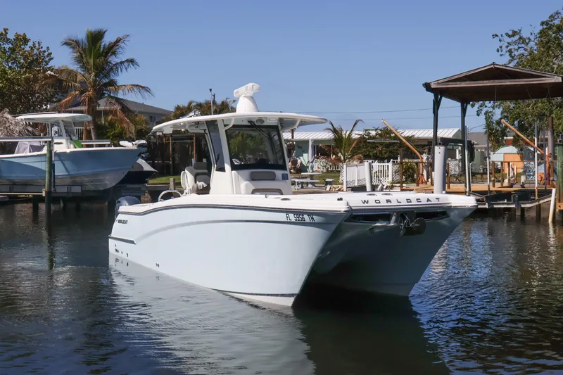 Slide: The Image of 2022 World Cat 280 CC-X boat docked in a serene marina setting. - 8