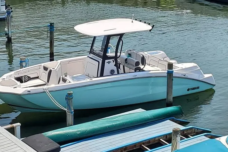 The Image of 2023 Yamaha Boats 255 FSH Sport E on trailer, parked outdoors. - 0