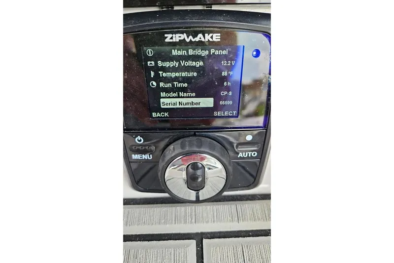 Slide: The Image of 2023 Yamaha Boats 255 FSH Sport E electrical compartment with wiring and battery components. - 21