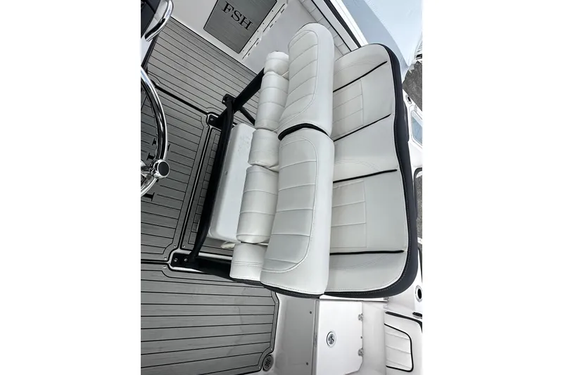 Slide: The Image of 2023 Yamaha Boats 255 FSH Sport E interior seating, featuring sleek white upholstery. - 24