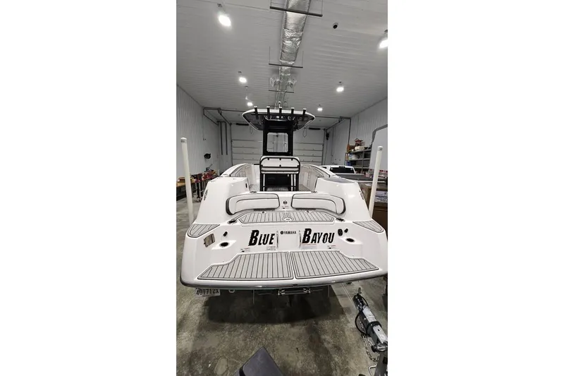 Slide: The Image of 2023 Yamaha Boats 255 FSH Sport E on a dock lift by waterfront homes. - 9