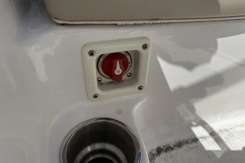 Slide: The Image of 2017 Robalo R160 Center Console boat detail with red switch and cup holder. - 10