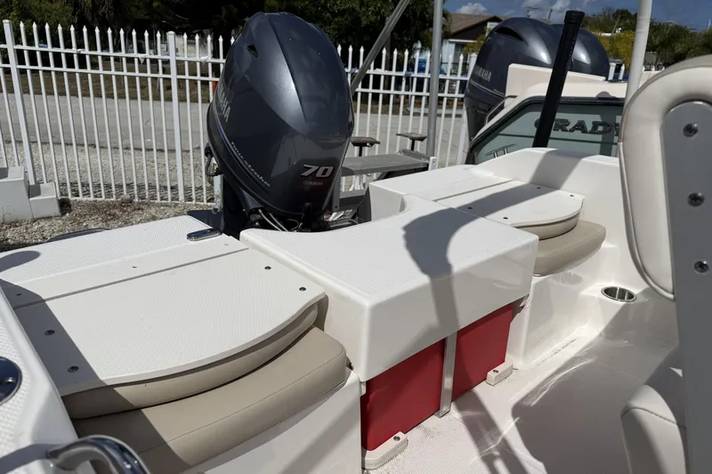 Slide: The Image of 2017 Robalo R160 Center Console boat with Yamaha 70 engine, white seating, and red storage. - 11