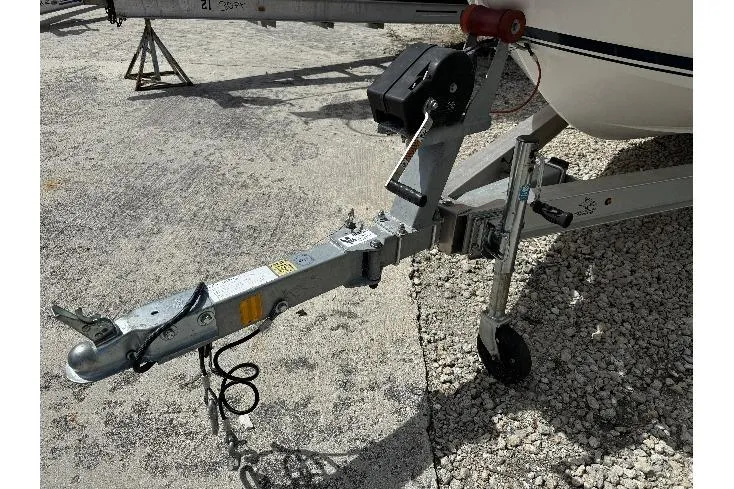 Slide: The Image of Trailer hitch of 2017 Robalo R160 Center Console boat on gravel surface. - 15