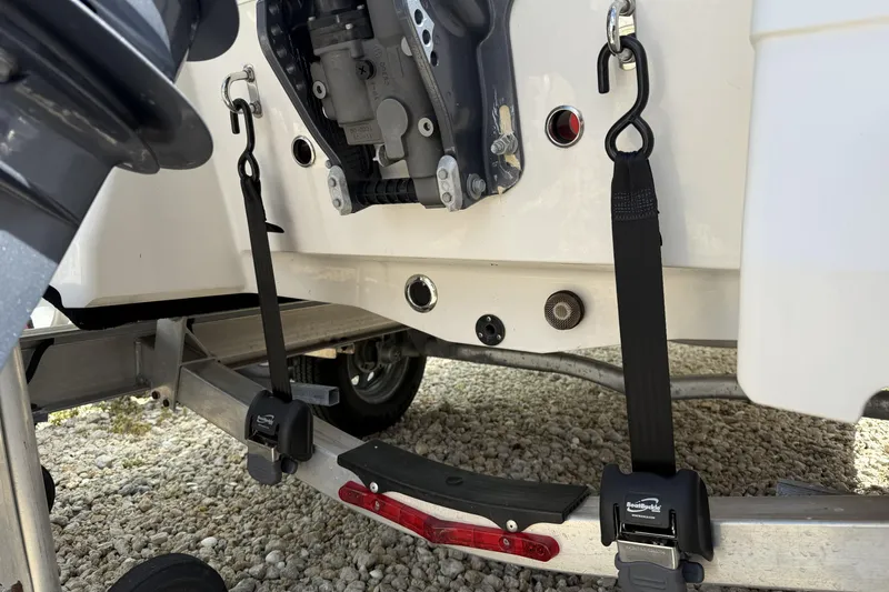 Slide: The Image of 2017 Robalo R160 Center Console boat secured on trailer with straps. - 7
