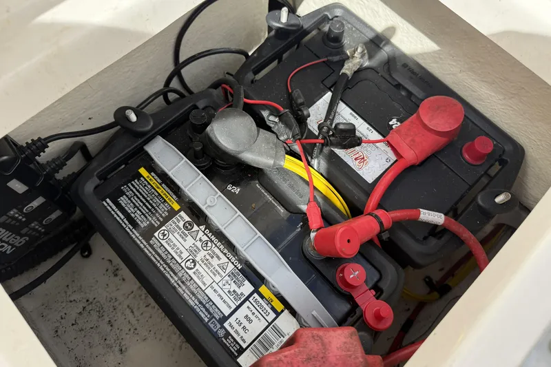 Slide: The Image of Battery compartment of a 2017 Robalo R160 Center Console boat with connected cables. - 9