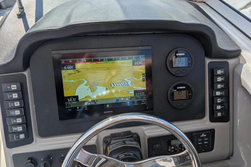 Slide: The Image of 2021 Robalo R247 Dual Console dashboard with Garmin navigation and Yamaha gauges. - 10
