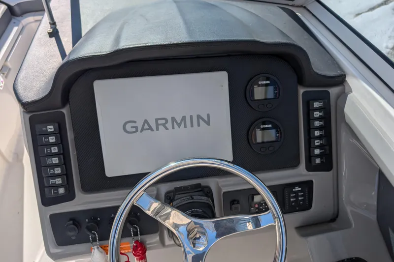 Slide: The Image of 2021 Robalo R247 Dual Console dashboard with Garmin display and Yamaha gauges. - 11