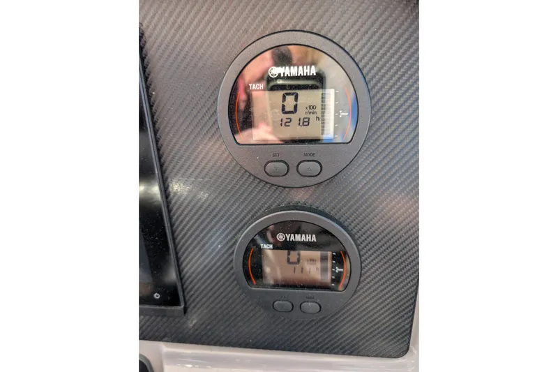 Slide: The Image of Yamaha tachometers on 2021 Robalo R247 Dual Console boat dashboard. - 12