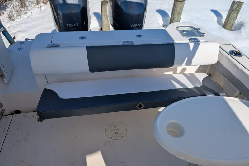 Slide: The Image of 2021 Robalo R247 Dual Console boat interior with seating and twin Yamaha 150 engines. - 19