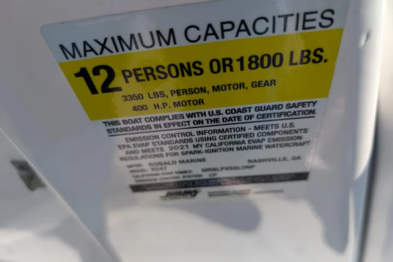 Slide: The Image of Capacity label on 2021 Robalo R247 Dual Console, max 12 persons or 1800 lbs. - 21
