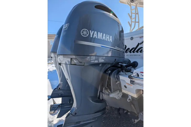 Slide: The Image of 2021 Robalo R247 Dual Console with Yamaha outboard motor in sunlight. - 9