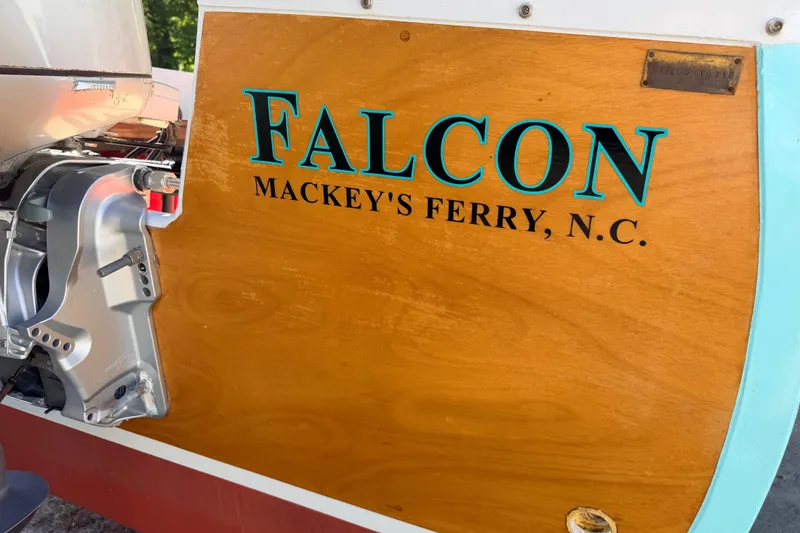Slide: The Image of Wooden boat stern with "Falcon, Mackey's Ferry, N.C." text, featuring a Custom Loon motor. - 10