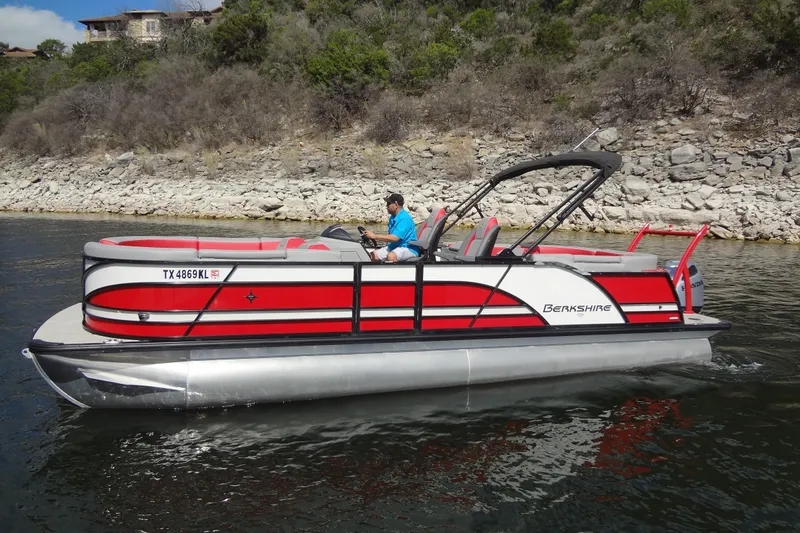 The Image of 2022 Berkshire 25RFX STS 3.0 pontoon boat on a scenic lake. - 0