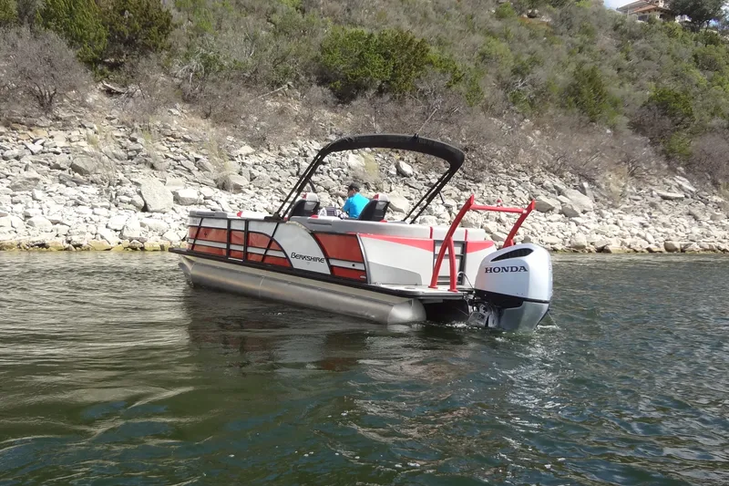 Slide: The Image of 2022 Berkshire 25RFX STS 3.0 pontoon boat on a scenic lake. - 10