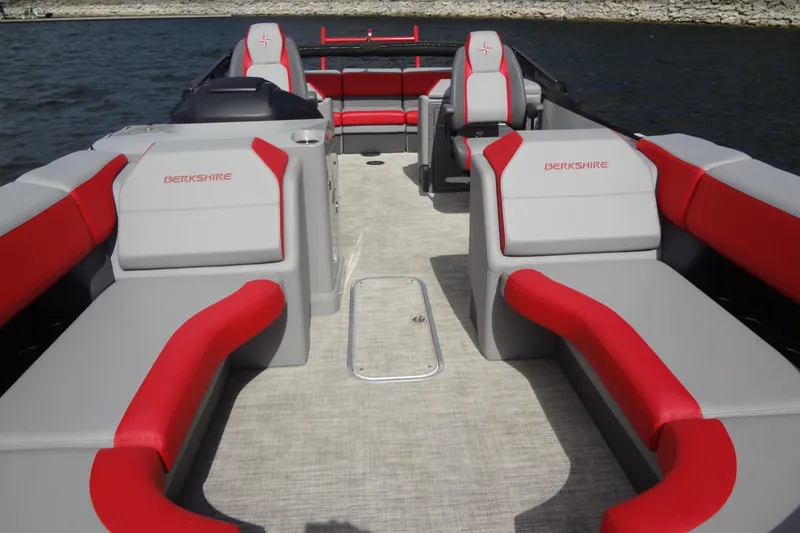 Slide: The Image of 2022 Berkshire 25RFX STS 3.0 pontoon boat with red and gray seating on the water. - 11