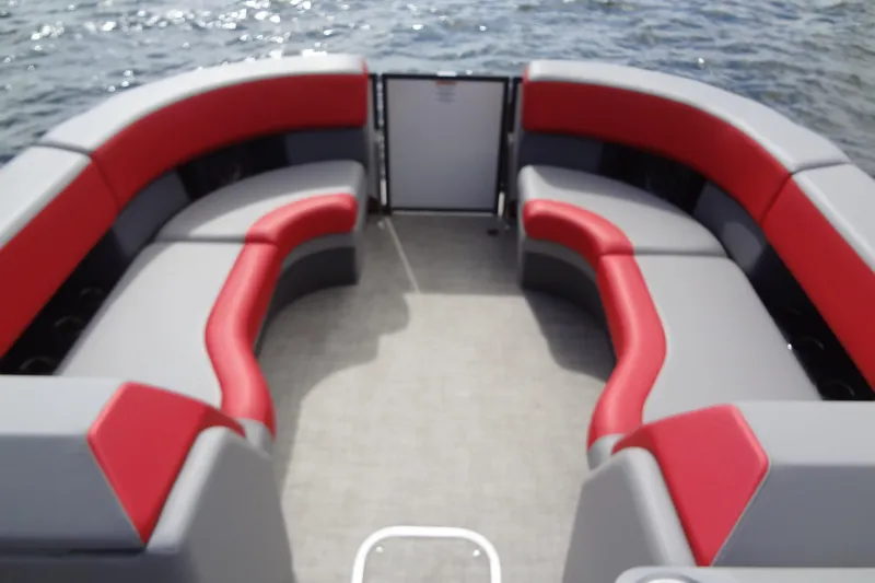 Slide: The Image of 2022 Berkshire 25RFX STS 3.0 pontoon boat with red and gray seating on water. - 12
