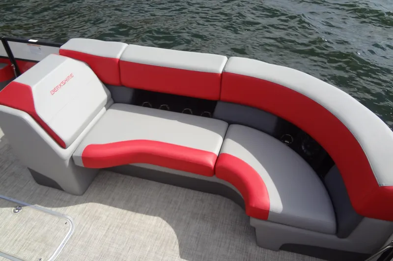 Slide: The Image of 2022 Berkshire 25RFX STS 3.0 boat with red and gray seating by the water. - 13