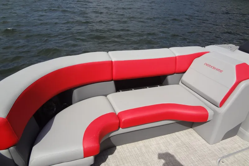 Slide: The Image of 2022 Berkshire 25RFX STS 3.0 boat with red and gray seating on water. - 14
