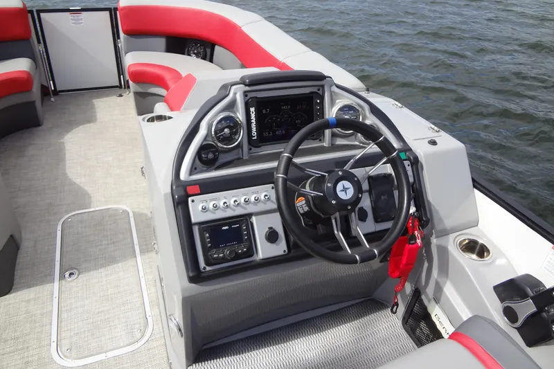 Slide: The Image of 2022 Berkshire 25RFX STS 3.0 boat dashboard with steering wheel and navigation controls. - 19