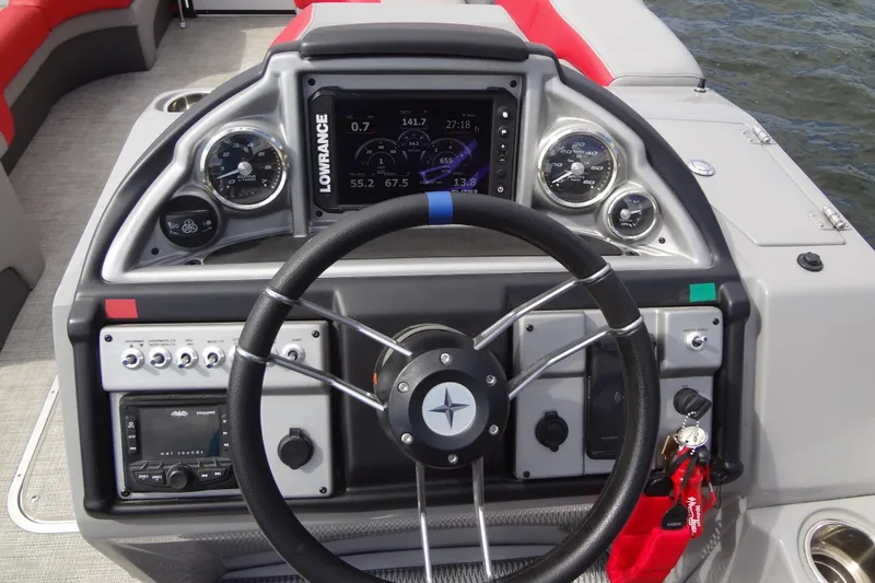 Slide: The Image of Steering console of 2022 Berkshire 25RFX STS 3.0 boat with navigation and control instruments. - 20