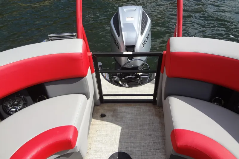 Slide: The Image of 2022 Berkshire 25RFX STS 3.0 boat interior with red and gray seating, Honda motor visible. - 29