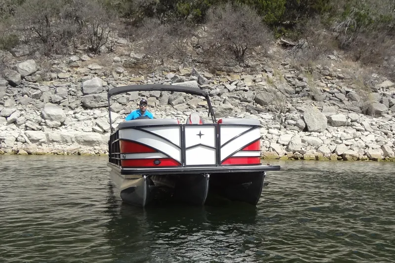 Slide: The Image of 2022 Berkshire 25RFX STS 3.0 pontoon boat on a rocky shoreline. - 3