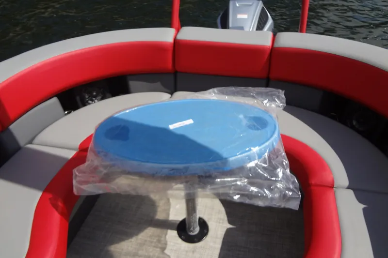 Slide: The Image of 2022 Berkshire 25RFX STS 3.0 boat interior with red and gray seating, blue table. - 30