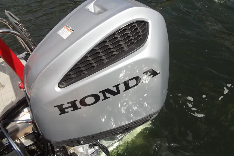 Slide: The Image of Silver Honda outboard motor on a 2022 Berkshire 25RFX STS 3.0 boat in water. - 34