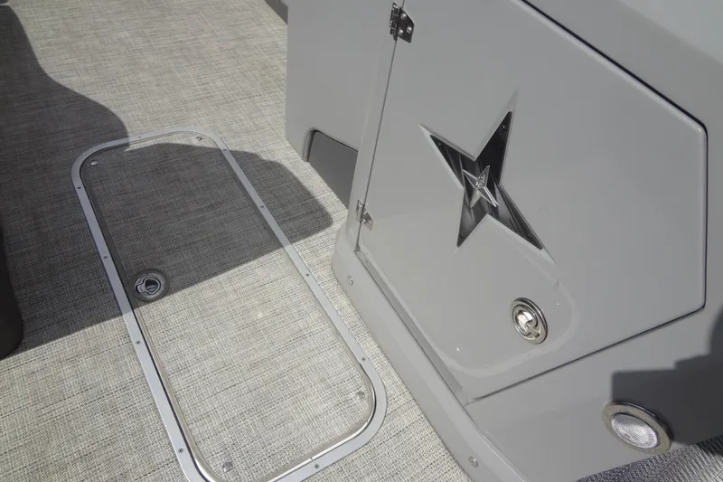 Slide: The Image of 2022 Berkshire 25RFX STS 3.0 boat interior with star emblem and storage hatch. - 37