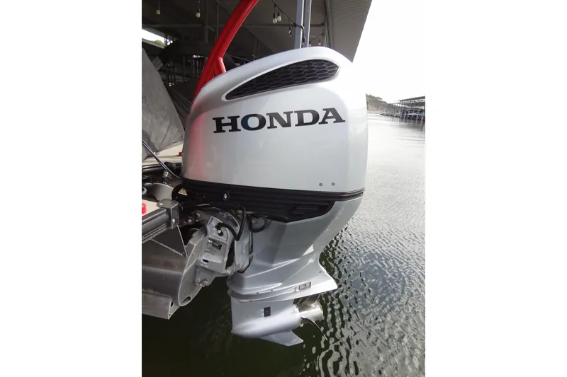 Slide: The Image of Outboard motor on 2022 Berkshire 25RFX STS 3.0 pontoon boat, docked on water. - 50