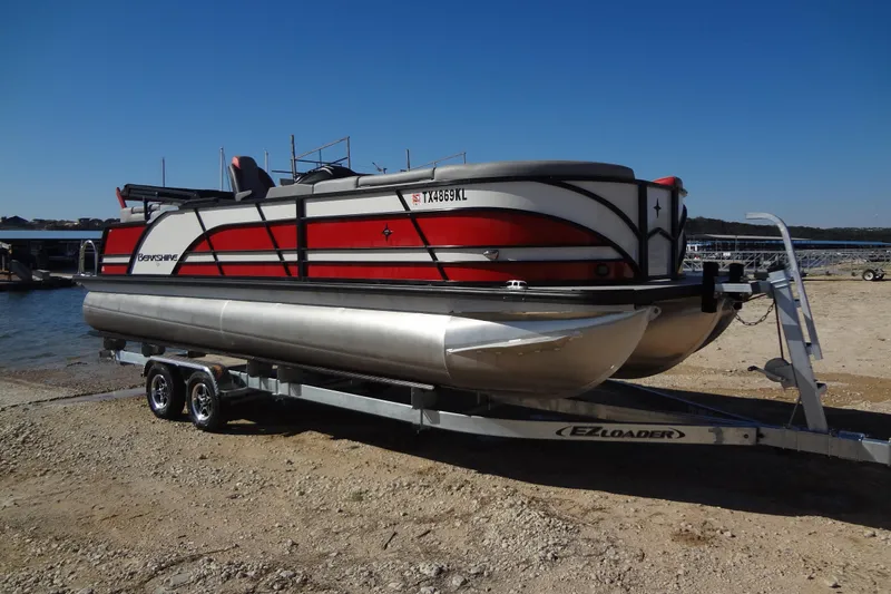 Slide: The Image of 2022 Berkshire 25RFX STS 3.0 pontoon boat on trailer by the lake. - 54