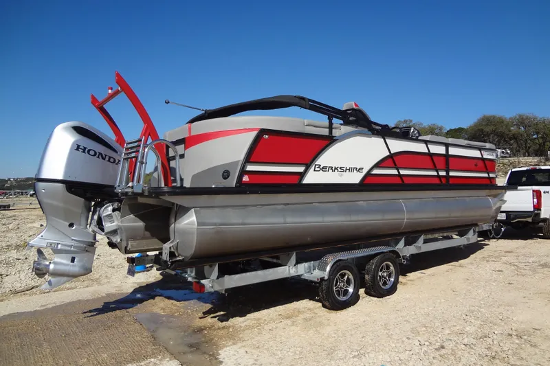 Slide: The Image of 2022 Berkshire 25RFX STS 3.0 pontoon boat on trailer with Honda outboard motor. - 56